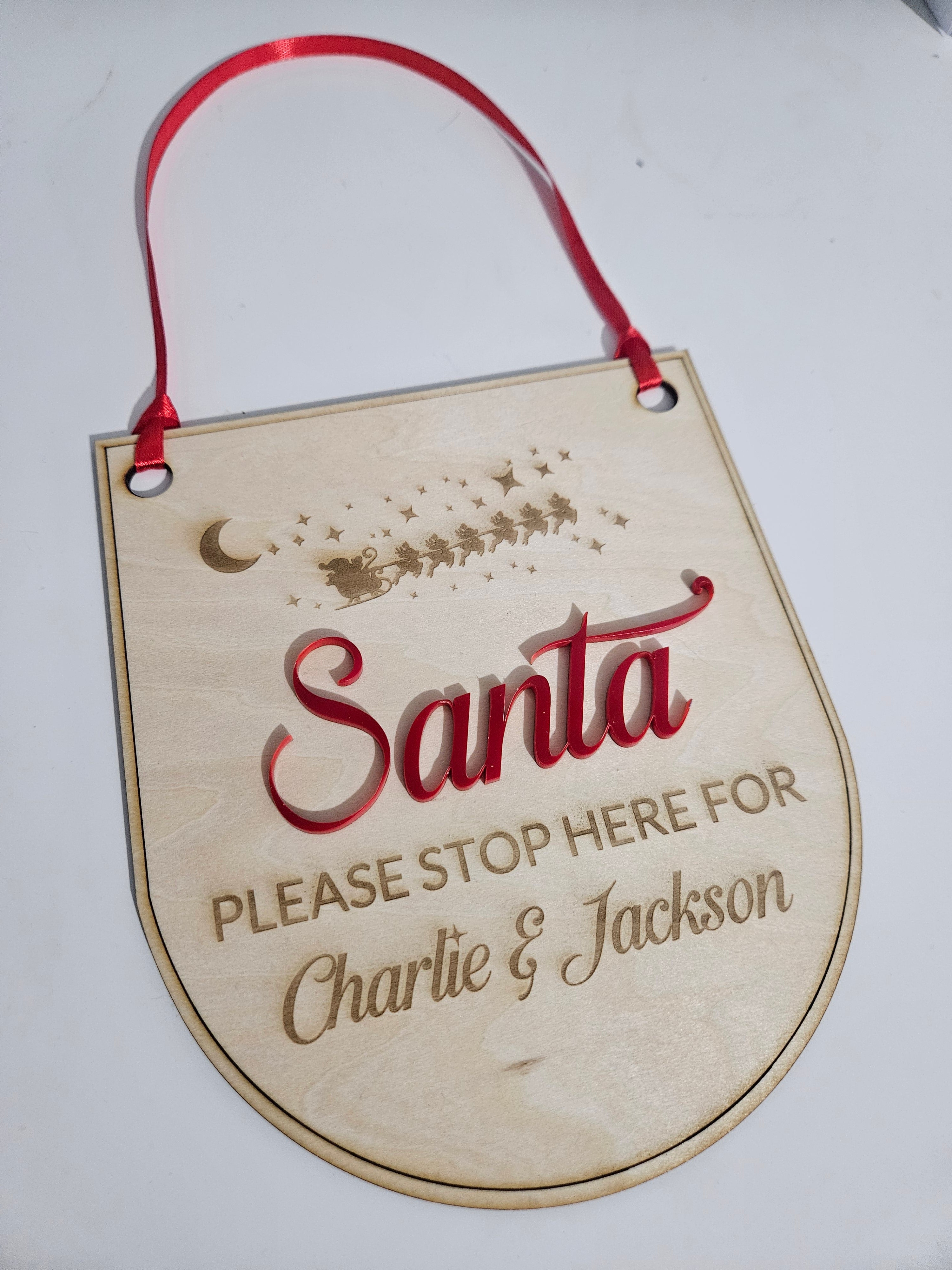 Personalised wooden Santa stop here signs.