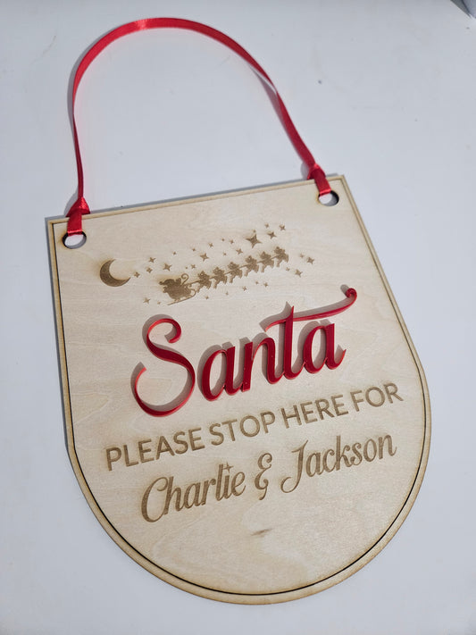 Personalised wooden Santa stop here signs.